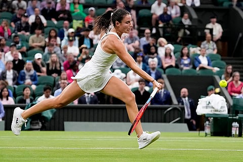 Emma Navarro plays a forehand return to Coco Gauff